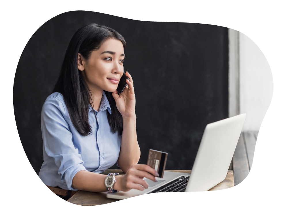 Business woman on business call while holding credit card